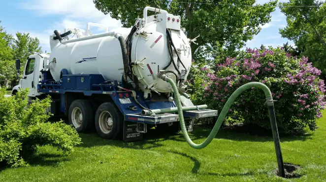 Professional vacuum truck performing residential drainage and septic maintenance in Sarasota, FL