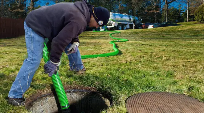 Service technician performing residential septic pumping and drainage maintenance in Sarasota, FL